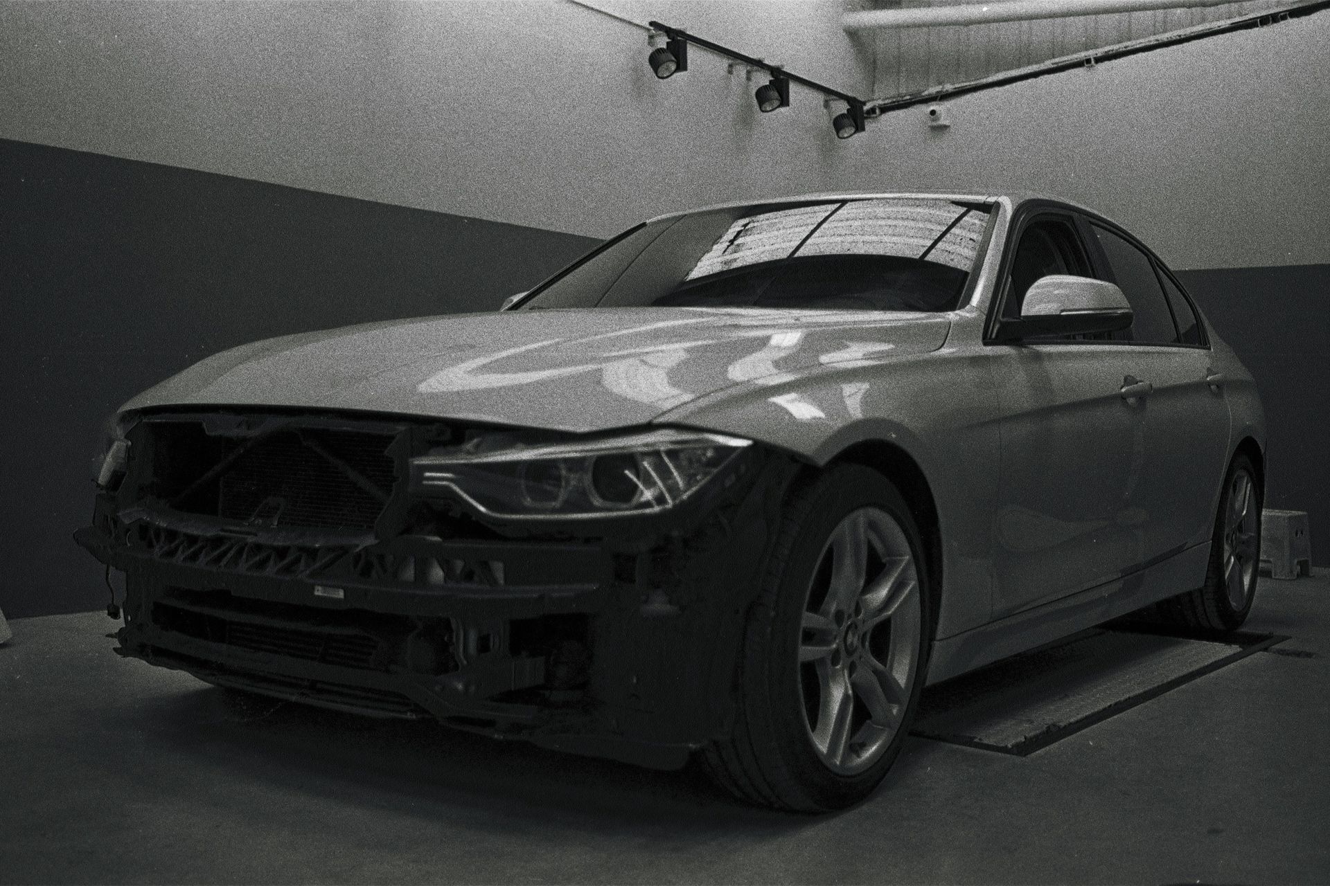 a black and white photo of a car in a garage