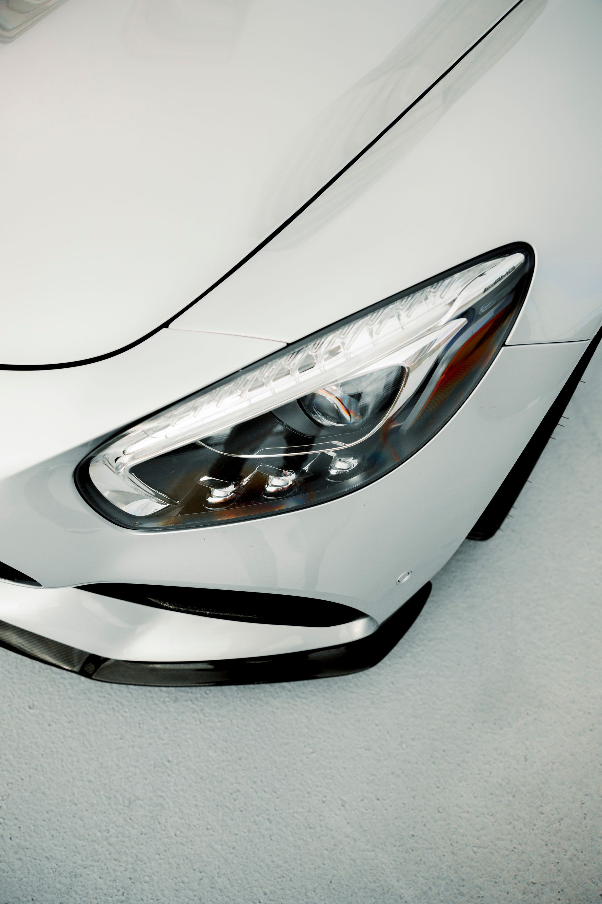 Close-up shot of a luxury car's sleek headlight showing modern design.